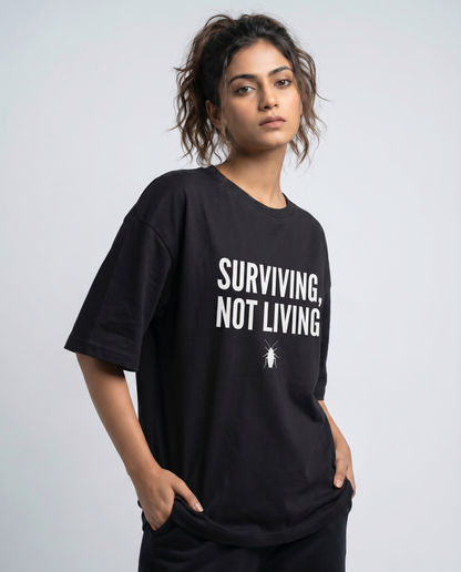 SURVIVING NOT LIVING — Oversized Black Tee | Cockroach Janta Party